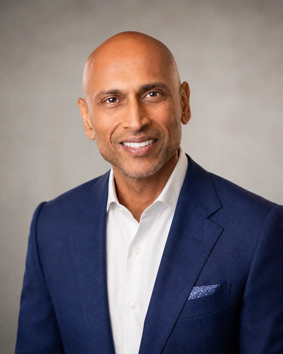 Dr. Manuj Agarwal in a blue suit
